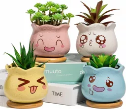 Małe doniczki ceramiczne z zabawnymi minami Małe doniczki ceramiczne z zabawnymi minami