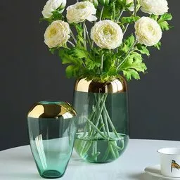 Złoto w połączeniu z delikatnym zielonym szkłem sprawia, że wazon wygląda lekko i elegancko